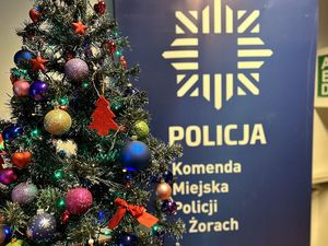 Fotografia choinki na tle rolupu żorskiej Policji