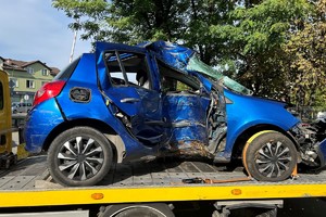 Na zdjęciu widać niebieski samochód, pojazd ma mocno uszkodzony bok.