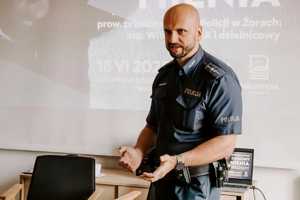 Na zdjęciu widać policjanta podczas spotkania z mieszkańcami.