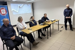 Na zdjęciu widać policjantów, przedstawicielkę sanepidu.