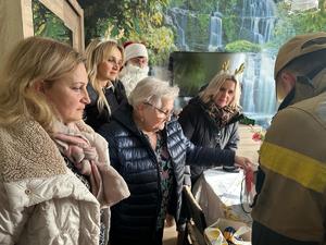 Na zdjęciu widać policjantów oraz inne osoby podczas akcji pomocowej.