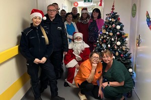 Na zdjęciu widać policjantów oraz inne osoby podczas akcji pomocowej.