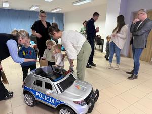 Na zdjęciu widać policjantów oraz przedszkolaków wraz z ich opiekunkami.
