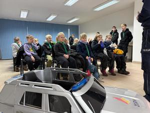 Na zdjęciu widać policjantów, zuchów i ich opiekunów podczas zwiedzania żorskiej komendy Policji.