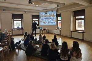 Na zdjęciu widać policjanta oraz uczestników półkolonii.