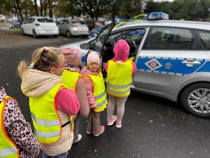 Na zdjęciu widać przedszkolaki oraz policjantów.